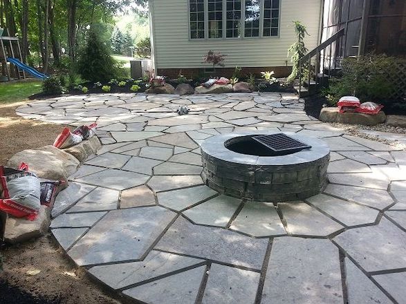 Installation of the bluestone patio and firepit eliminated the areas of water-logged grass.