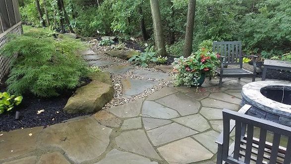 The irregular bluestone and gravel path prevents the previously overwhelmingly marshy conditions while wedding the natural and man-made elements of this design.