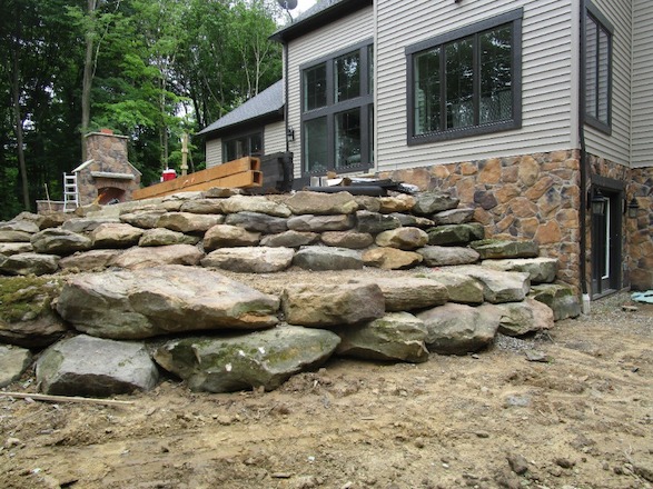 Toprock outcroppings were the obvious choice for the heavy duty job of holding back the earth while still keeping with the natural feel.
