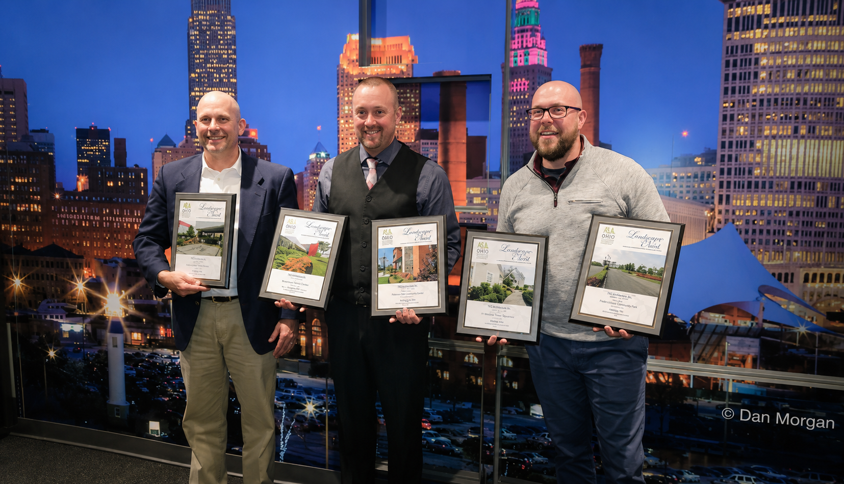 Three Rice's Landscaping team members holding Ohio Landscape Association awards recognizing excellence in landscape design, installation, and maintenance.